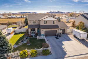 Front of property with a mountain view, a front yard, and a garage