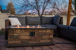 Patio terrace at dusk featuring a fire pit