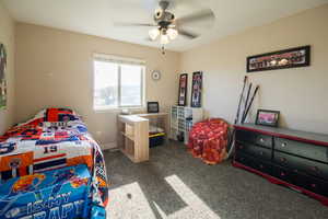 Carpeted bedroom with ceiling fan