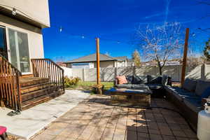 View of patio featuring an outdoor living space with a fire pit