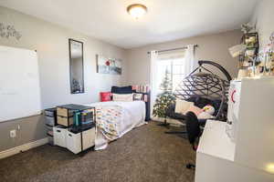 Bedroom featuring dark colored carpet