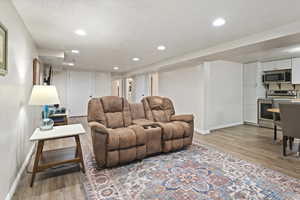 Living room featuring a textured ceiling and light wood-type flooring