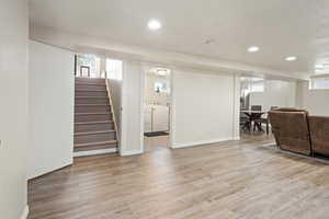 Living room with light hardwood / wood-style flooring and independent washer and dryer