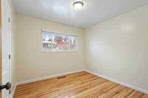 Empty room featuring light wood-type flooring