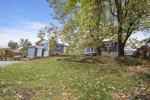 View of yard featuring a storage unit