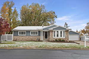 View of front of house featuring a garage and a front lawn