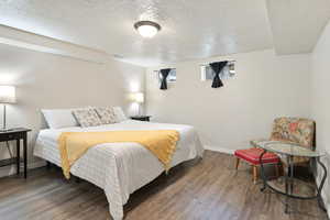 Bedroom featuring hardwood / wood-style flooring and a textured ceiling