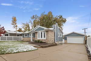 Ranch-style home with a garage and an outbuilding