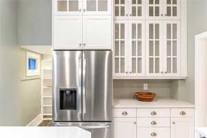 Kitchen featuring stainless steel fridge.