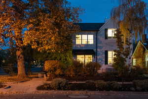 Dusk view of side of house and private garden.