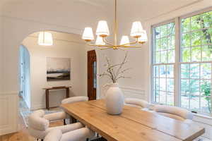 Dining room with new hardwood flooring and a new chandelier