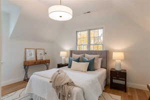 Owner's suite, bedroom with hardwood flooring.