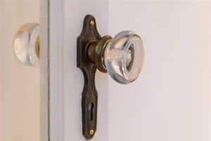 Glass ornate door handle to study/library on main floor next to living room.