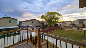 Deck at dusk with a gazebo and a yard