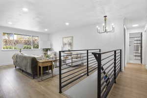 Interior space featuring a textured ceiling, crown molding, and light hardwood / wood-style flooring