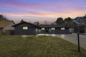 Ranch-style house with a mountain view, a yard, and a garage