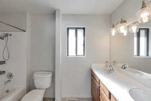 Full bathroom featuring shower / bathing tub combination, vanity, toilet, and tile patterned flooring