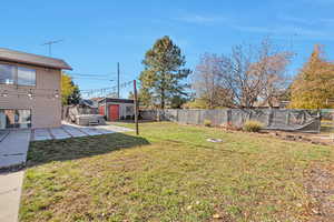 View of yard with a patio and a storage unit