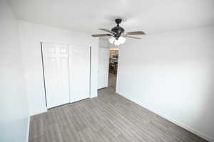 Unfurnished bedroom featuring a closet, ceiling fan, and tile floors