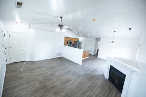 Unfurnished living room with tile flooring, ceiling fan, and lofted ceiling