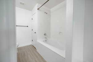 Master Bathroom featuring washtub / shower combination, deep soaker tub and tile floors