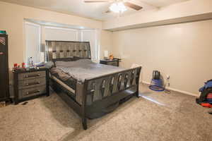 large primary Bedroom featuring ceiling fan and carpet and Bay Window