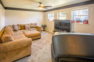 Living room featuring plenty of natural light, daylight windows w/view of mountains, ceiling fan,