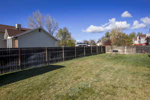 View of yard featuring large fenced yard. A large cement patio or pad for RV or ? in back side yard not pictured