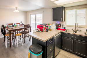 Kitchen featuring dishwasher, sink,  and  dining with slider to deck. Hook ups for 2nd laundry