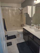 Full bathroom featuring shower / bath combo, vanity, and toilet