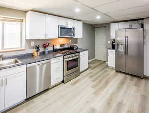 Kitchen with appliances with gas stove ,sink, dishwasher µwave, Entry door to garage for private living