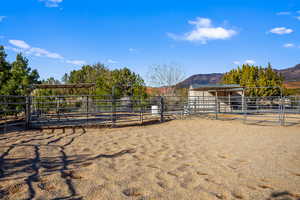 View of horse barn featuring a mountain view and a rural view