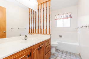 Bathroom featuring tile patterned floors, a bathtub, toilet, and vanity