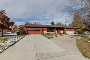 Single story home featuring a porch and a garage