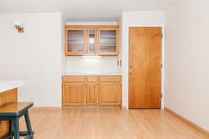 Kitchen with light hardwood / wood-style floors