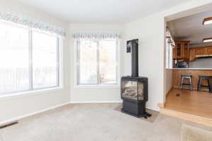 Living room featuring light wood-type flooring and a wood stove