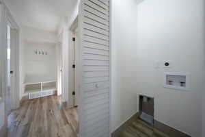 Washroom featuring hookup for an electric dryer, hookup for a washing machine, and light hardwood / wood-style flooring