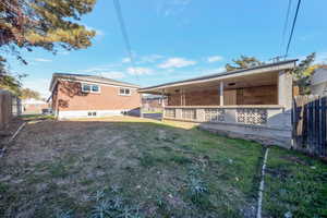 Rear view of house featuring a lawn