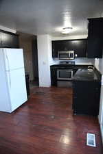 Kitchen featuring sink, dark wood-type flooring, and appliances with stainless steel finishes