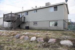 Back of house featuring a wooden deck