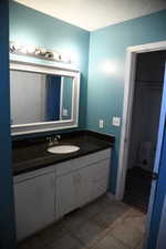 Bathroom with tile patterned floors and vanity