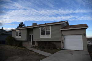 Split foyer home featuring a garage