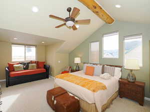 Bedroom with vaulted ceiling with beams, light carpet, and ceiling fan