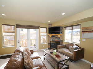 Living room featuring light carpet and a fireplace