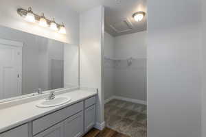 Bathroom with hardwood / wood-style flooring and vanity