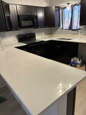 Kitchen with sink and black appliances