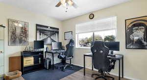 Home office with a textured ceiling, hardwood / wood-style flooring, and ceiling fan