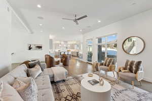 Living room with ceiling fan and hardwood / wood-style flooring