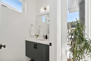 Bathroom with vanity and a healthy amount of sunlight