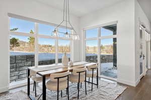 Dining area with dark hardwood / wood-style flooring and a chandelier